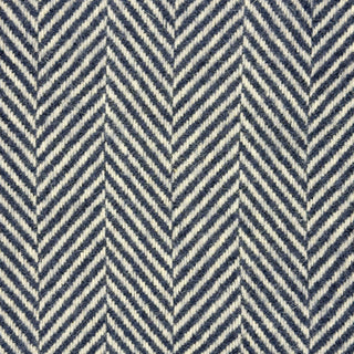 Close-up texture detail of a navy herringbone recycled wool blanket showing the woven herringbone pattern and soft wool fibers
