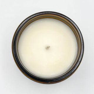 soy candle amber jar top view open wax surface white background