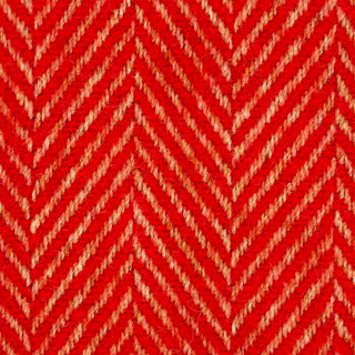 Close-up texture detail of a bright red herringbone recycled wool blanket showing the woven herringbone pattern and soft wool fibers