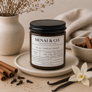 Vanilla and cinnamon soy candle in amber glass jar styled with cinnamon sticks, vanilla beans, cloves, soft linen, and warm neutral decor